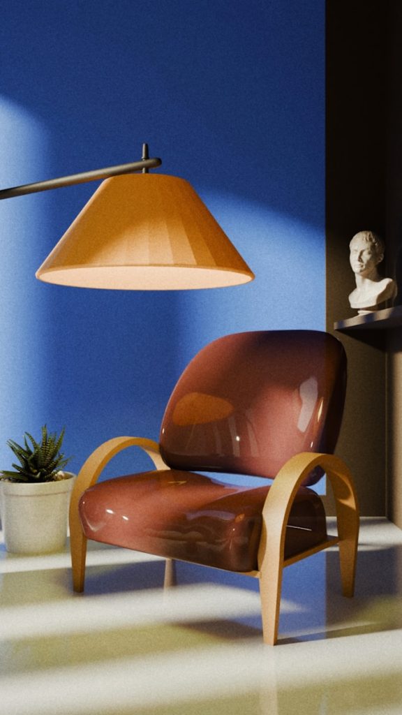 A modern armchair with a lamp and bust.